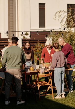 Family enjoying outdoor meal and drinks in the garden.